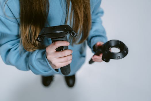 Detailed view of a person holding virtual reality controllers, engaging in immersive gaming.